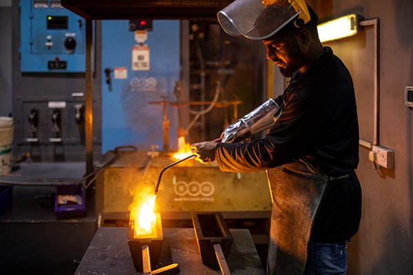 Molten gold being poured from a crucible at the SAM refinery
